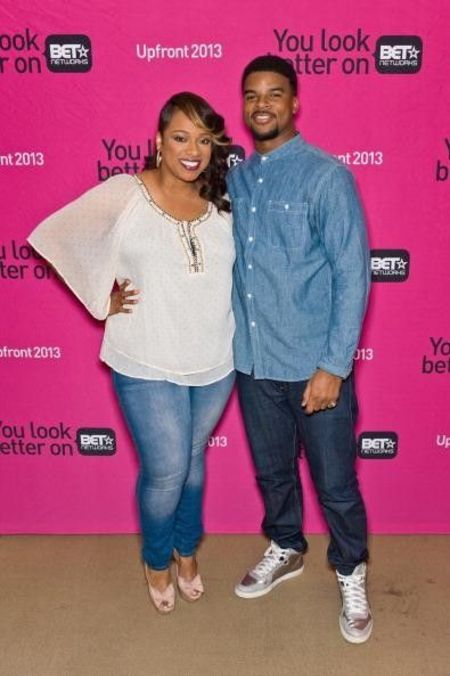 John Drew Sheard in a blue shirt poses with sister Kierra Sheard.